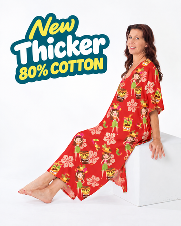 Woman lounging in the full-length red Cheeky Tiki caftan with island girl and tiki mask print
